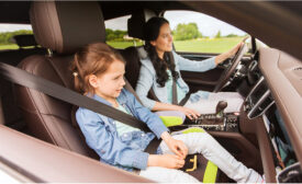 Photo of the interior of a car with a mother and child sitting in the seats