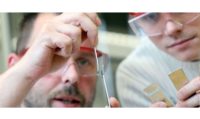 image of two people in saftey glasses working in a lab