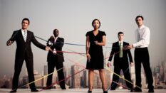 Image of people dressed in black holding tape