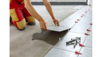 Photo of man installing ceramic tiles