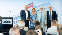 Photo of people standing next to podium at the Rohm Innovation Center