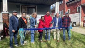 Picture of people in front of Habitat for Humanity International's Loctite 2nd Chance House.