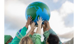 Picture of people holding up a globe