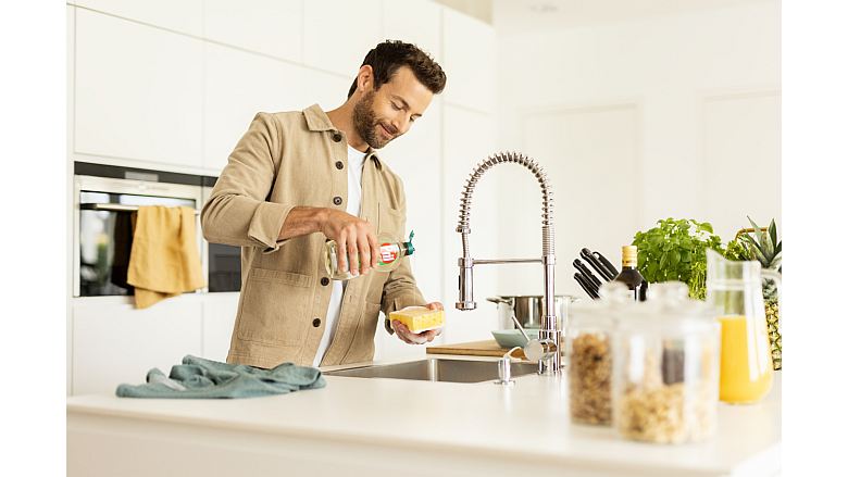 Image of a man utilizing Henkel's Wash-Off Adhesive