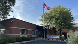 Picture of Franklin International headquarters -- a brown brick building with an American flag flying in the front